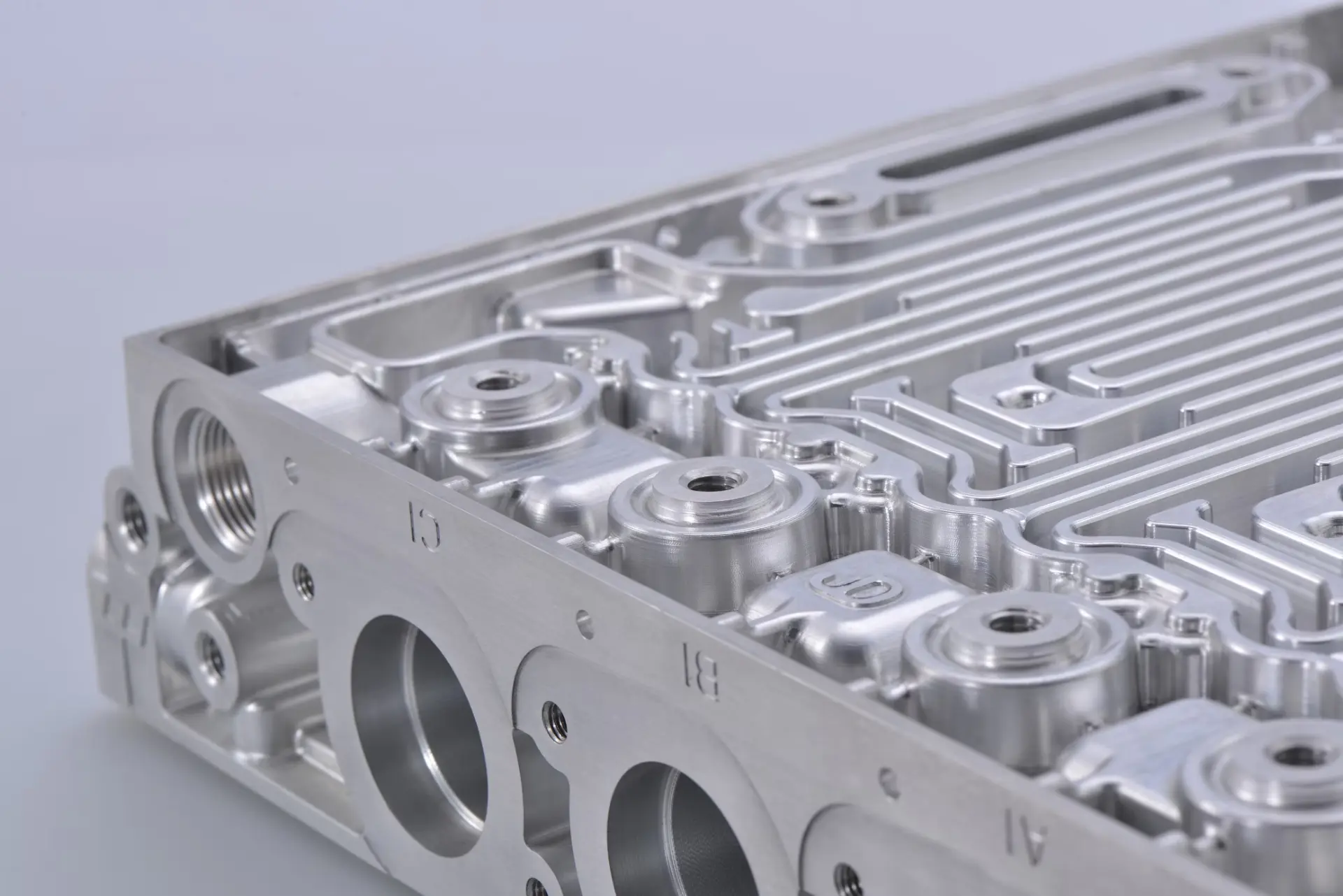 Precision CNC machined aluminum manifold with threaded ports and coolant channels